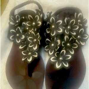 Black flat sandals with floral design.   New 10